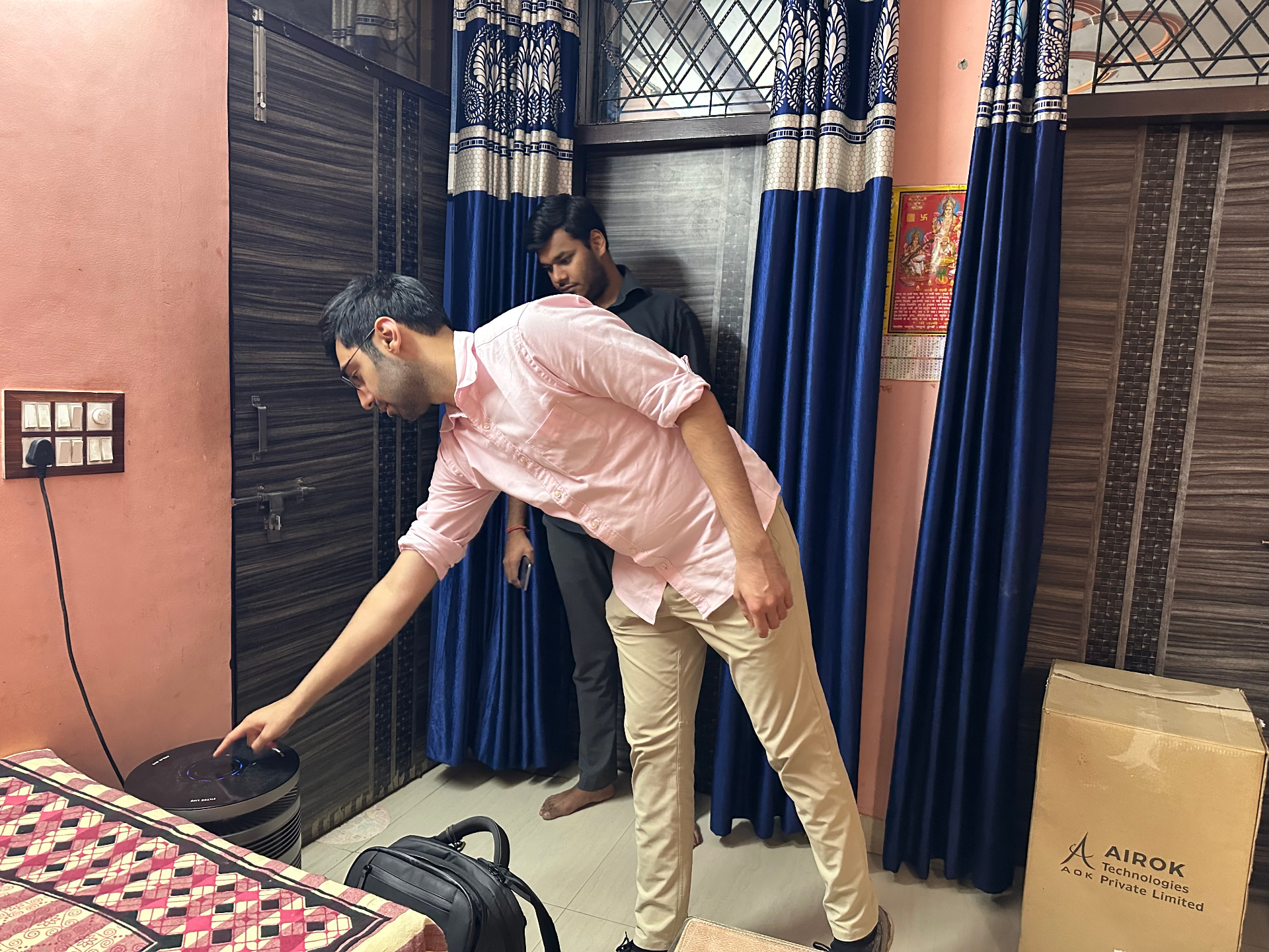 Assessing a patient's home in India for air purifier placement.